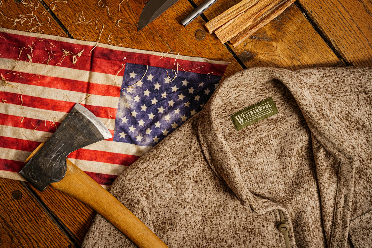 Outdoor adventure gear including an axe, flag, and survival tools.